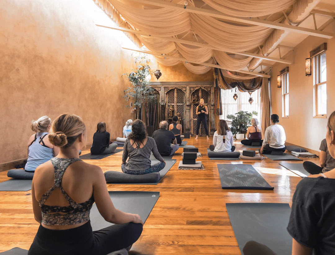 A group practising yoga in a warm studio
